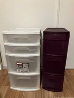 Front view of both storage towers: white 4-drawer unit and purple 3-drawer unit.