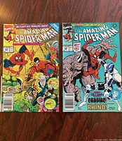Photo showing two comic issues: The Amazing Spider-Man #343 with a yellow background and #344 with a blue background.