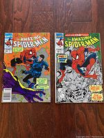 Three vintage The Amazing Spider-Man comic books laid out on wood surface, showing front covers with Spider-Man and villains.