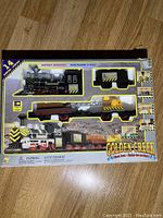 Front view of Golden Creek vintage battery operated train set in original box, showing locomotive and cars