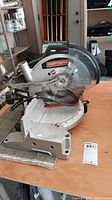 Front view of Craftsman miter saw showing branding and blade cover.