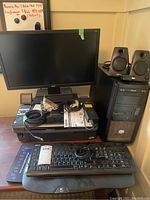 Photo showing ACER monitor, Epson printer beneath it, ASUS CPU tower to right, two Logitech speakers on CPU tower, and ACER wired keyboard in front.
