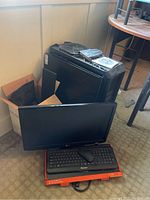 Overview of PC tower, LG monitor, Blackweb keyboard and mouse on carpet