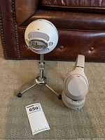 Overview of Sony headphones beside Blue Snowball microphone on tripod with auction tag visible