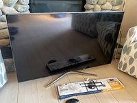 TV on floor with stand, wall mount box and cables