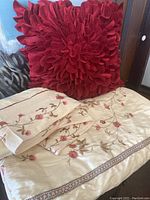 Full view of the bedding set with flat sheet, duvet cover, and burgundy floral pillow on a bed.