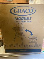Front of box showing Graco logo, Floor2Table name and 7-in-1 highchair illustration