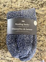 Photo showing packaged men's reading socks by Indigo, indigo blue and white marled knit with label.