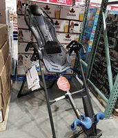 Front-angle view of Teeter inversion table fully assembled, showing frame, backrest, ankle cradle and safety tether