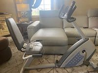 Side photo of the Weslo Pro 10.8 recumbent bike showing padded backrest, seat, pedal pedals, frame details, and handlebar with mounted monitor and fan.