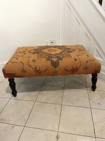 Front view showing full ottoman and turned hardwood legs
