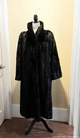 Front full-length view of dark brown mink coat on mannequin