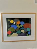 Framed abstract pastel artwork featuring colorful rounded shapes with black outlines by B. Weis.