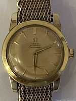 Close-up front view showing honeycomb dial and mesh bracelet