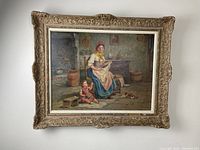 Full view of framed oil painting depicting a mother and child in a rustic interior.