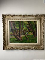 Full view of the framed original oil painting showing the wooded park scene with a man and woman in Toronto's High Park.