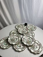 Ten India Tree salad plates arranged on table with green apple for scale