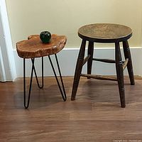Both stools side by side on wooden floor, showing overall size and design differences.