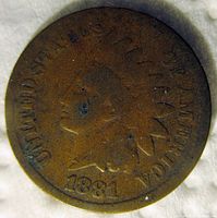 Obverse side of 1881 Indian Head Cent showing Liberty profile and date with wear marks.