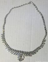 Full view of 16 inch flared art deco style rhinestone necklace with clasp visible.