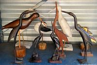 Overview photo of the eleven shore bird figures arranged on a surface, showing variety of colors, sizes and mounting styles.