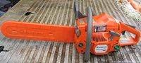 Side view of chainsaw with bar cover installed