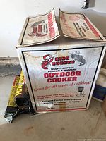 Boxed King Kooker multi-purpose portable propane outdoor cooker with branding and usage info on box
