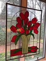 Full view of stained glass panel hanging in window