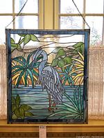 Full front view of the stained glass panel hanging in window