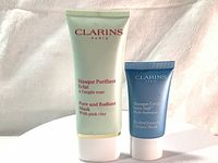 Front view of the two tubes: Pure Radiant Mask (green tube) and HydraQuench Cream-Mask (blue tube).