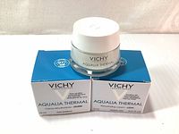 Two blue and white Vichy Aqualia Thermal Cream boxes with one jar displayed on top showing front branding.