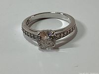 Front view of white gold rhodium plated ring with large round Swarovski crystal centerpiece