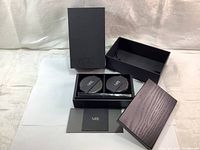 NARS black wooden gift box with lid removed, showing compartments and brush slot, with outer packaging and NARS card