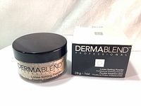 Photo showing the jar and box of Dermablend Professional loose setting powder, clearly displaying brand and product name.