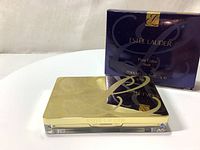 Estee Lauder Pure Color Blush compact closed next to its original box showing front and top with branding.