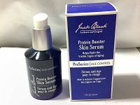 Front view of Jack Black Protein Booster Skin Serum bottle next to its box, showing branding and product name details.