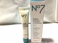 Front view of the N°7 Protect & Perfect serum tube and box showing branding and product name in English and French.