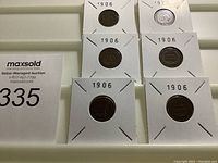 Six 1906 Indian Head cents in cardboard flips displayed in tray