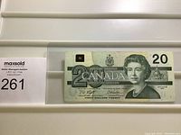 Front side of 1991 Canadian $20 bill with Queen Elizabeth II portrait, denomination, and signatures.