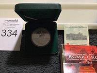 1998 Canadian silver proof dollar in green velvet presentation box with commemorative packaging visible.