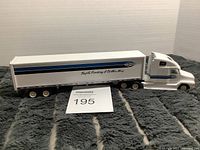 Side profile of Dana branded semi-truck model with trailer, showing branding and slogan on side.