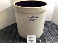 Front view of large beige ceramic crock with blue crown and number 3 marking on the front.