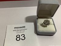 Image of estate ring in cushioned ring box with auction lot number visible for identification.
