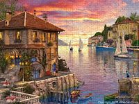 Completed puzzle showing Mediterranean harbour scene with houses, boats, and sunset.