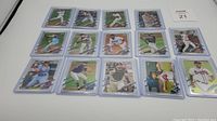 18 individually sleeved 2021 Topps Chrome rookie baseball cards laid out in three rows on a white surface.