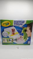 Photo of Crayola Sketch Wizard packaging showing the projector and how it works projecting images for tracing and drawing.
