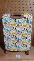 Front view of the hardcase suitcase with colorful cat and flower print on white background.