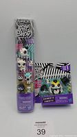 Photo of lot showing a tall sealed package with five Littlest Pet Shop Series One figures and a smaller box with one figure.