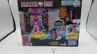Full front view of the unopened Monster High Stage Fright Mega Bloks set featuring Catty Noir and concert stage elements in box.