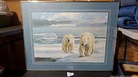 Overall front view showing two polar bears walking on ice framed behind glass with a blue double mat.